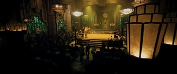 Movie still from “Ip Man 2” (2010), directed by Wilson Yip – A boxing ring in a large room with people watching it; Extreme Wide shot, High angle