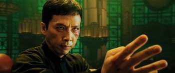 Movie still from “Ip Man 2” (2010), directed by Wilson Yip – A person wearing a black shirt; Close Up shot, Low angle