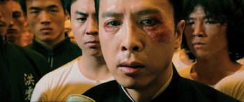 Movie still from “Ip Man 2” (2010), directed by Wilson Yip – Two asian men with bruises on their faces; Close Up shot, Low angle
