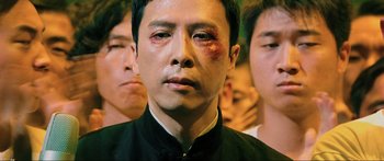 Movie still from “Ip Man 2” (2010), directed by Wilson Yip – A person with a bruise on his face; Close Up shot, Low angle