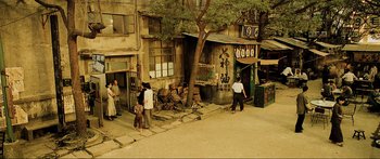 Movie still from “Ip Man 2” (2010), directed by Wilson Yip – An old street scene with people walking around; Extreme Wide shot, High angle
