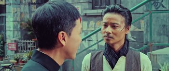 Movie still from “Ip Man 3” (2015), directed by Wilson Yip – A man in a black shirt is looking at another man in a white shirt; Close Up shot, Over the shoulder angle