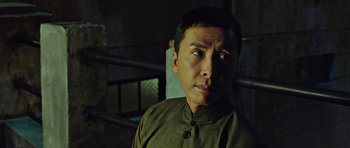 Movie still from “Ip Man 3” (2015), directed by Wilson Yip – A person wearing a brown shirt; Close Up shot, Low angle