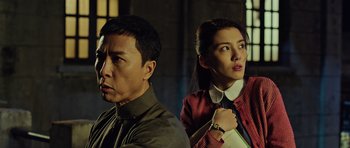 Movie still from “Ip Man 3” (2015), directed by Wilson Yip – A man and a woman standing next to each other; Medium shot, Low angle
