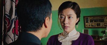 Movie still from “Ip Man 3” (2015), directed by Wilson Yip – A man and a woman looking at each other in a mirror; Close Up shot, Over the shoulder angle