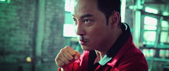 Movie still from “Ip Man 3” (2015), directed by Wilson Yip – A person wearing a red shirt; Close Up shot, Low angle