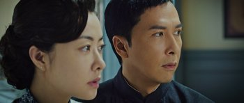 Movie still from “Ip Man 3” (2015), directed by Wilson Yip – A man and a woman looking at the camera; Close Up shot, Low angle