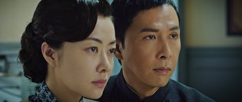 Movie still from “Ip Man 3” (2015), directed by Wilson Yip – A man and a woman are looking at the camera; Close Up shot, Low angle