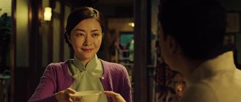 Movie still from “Ip Man 3” (2015), directed by Wilson Yip – A young woman holding a bowl in front of another woman; Close Up shot, Over the shoulder angle