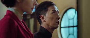 Movie still from “Ip Man 3” (2015), directed by Wilson Yip – A person looking at something; Close Up shot, Low angle