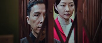 Movie still from “Ip Man 3” (2015), directed by Wilson Yip – A man and a woman standing next to each other; Close Up shot, Low angle