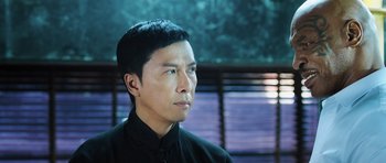 Movie still from “Ip Man 3” (2015), directed by Wilson Yip – A person wearing a black shirt; Close Up shot, Low angle