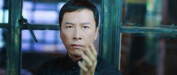Movie still from “Ip Man 3” (2015), directed by Wilson Yip – A person wearing a black shirt; Close Up shot, Low angle