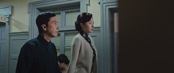 Movie still from “Ip Man 3” (2015), directed by Wilson Yip – A man and a woman are walking in a room; Medium shot, Over the shoulder angle