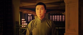 Movie still from “Ip Man 3” (2015), directed by Wilson Yip – A man in a green shirt is looking at the camera; Close Up shot, Low angle