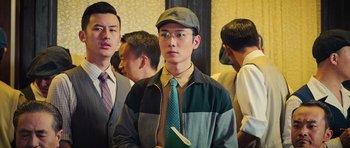 Movie still from “Ip Man 3” (2015), directed by Wilson Yip – A group of young men standing next to each other; Medium shot, Over the shoulder angle