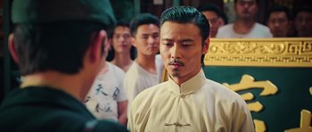 Movie still from “Ip Man 3” (2015), directed by Wilson Yip – A group of men standing in front of each other; Close Up shot, Over the shoulder angle