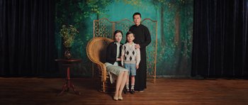 Movie still from “Ip Man 3” (2015), directed by Wilson Yip – A man and a woman standing next to a young boy; Medium shot, High angle