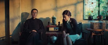 Movie still from “Ip Man 3” (2015), directed by Wilson Yip – A man and a woman sitting next to each other; Medium shot, Low angle