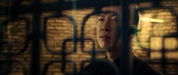 Movie still from “Ip Man 3” (2015), directed by Wilson Yip – A man looking out of a window at a brick wall; Close Up shot, Low angle