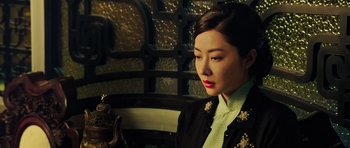 Movie still from “Ip Man 3” (2015), directed by Wilson Yip – A woman in a black jacket is looking down; Close Up shot, Over the shoulder angle