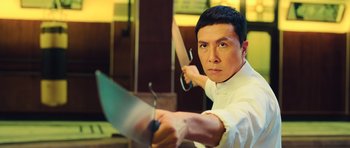 Movie still from “Ip Man 3” (2015), directed by Wilson Yip – A man holding a sword in his hands; Medium shot, Low angle