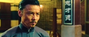 Movie still from “Ip Man 3” (2015), directed by Wilson Yip – A person wearing a suit and tie; Close Up shot, Low angle