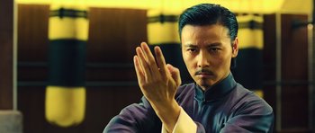 Movie still from “Ip Man 3” (2015), directed by Wilson Yip – A man in a black shirt and a white shirt; Close Up shot, Low angle