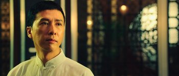 Movie still from “Ip Man 3” (2015), directed by Wilson Yip – A person wearing a white dress shirt; Close Up shot, Low angle