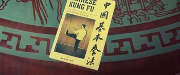 Movie still from “Ip Man 4: The Finale” (2019), directed by Wilson Yip – A book about chinese kung fu is sitting on a table; Extreme Close Up shot, Overhead angle