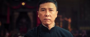 Movie still from “Ip Man 4: The Finale” (2019), directed by Wilson Yip – A person wearing a black shirt; Close Up shot, Low angle
