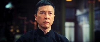 Movie still from “Ip Man 4: The Finale” (2019), directed by Wilson Yip – A person wearing a black shirt; Close Up shot, Low angle