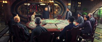Movie still from “Ip Man 4: The Finale” (2019), directed by Wilson Yip – A group of people sitting around a round table; Wide shot, Over the shoulder angle