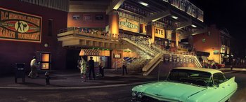 Movie still from “Ip Man 4: The Finale” (2019), directed by Wilson Yip – A group of people standing next to a building; Extreme Wide shot, High angle