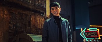 Movie still from “Ip Man 4: The Finale” (2019), directed by Wilson Yip – A man standing in front of a brick wall; Medium shot, Low angle