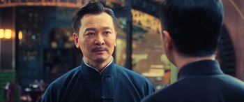 Movie still from “Ip Man 4: The Finale” (2019), directed by Wilson Yip – A man in a blue shirt is looking at himself in the mirror; Close Up shot, Over the shoulder angle