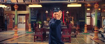 Movie still from “Ip Man 4: The Finale” (2019), directed by Wilson Yip – A man standing in front of a dining room table; Medium shot, Low angle