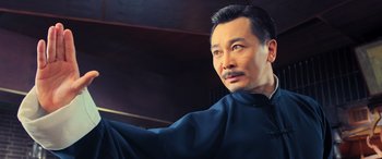 Movie still from “Ip Man 4: The Finale” (2019), directed by Wilson Yip – A person wearing a blue shirt; Close Up shot, Low angle