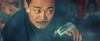 Movie still from “Ip Man 4: The Finale” (2019), directed by Wilson Yip – A person holding a cloth; Close Up shot, Over the shoulder angle