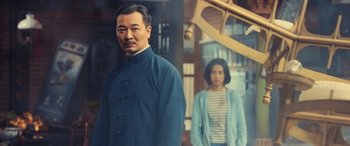 Movie still from “Ip Man 4: The Finale” (2019), directed by Wilson Yip – A man and a woman standing next to each other; Medium shot, Low angle