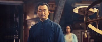 Movie still from “Ip Man 4: The Finale” (2019), directed by Wilson Yip – A man in a blue shirt and a woman in a blue dress; Medium shot, Low angle