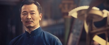 Movie still from “Ip Man 4: The Finale” (2019), directed by Wilson Yip – A person wearing a blue shirt; Close Up shot, Low angle
