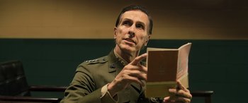 Movie still from “Ip Man 4: The Finale” (2019), directed by Wilson Yip – A man in a military uniform holding a book; Close Up shot, Low angle