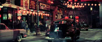 Movie still from “Ip Man 4: The Finale” (2019), directed by Wilson Yip – A car parked on the side of the street at night; Extreme Wide shot, High angle