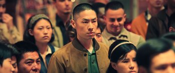 Movie still from “Ip Man 4: The Finale” (2019), directed by Wilson Yip – A group of people standing in a room; Medium shot, Over the shoulder angle