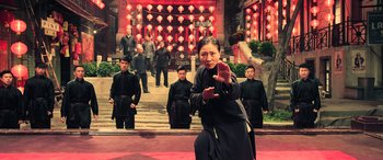 Movie still from “Ip Man 4: The Finale” (2019), directed by Wilson Yip – A group of people standing in front of a building; Wide shot, Low angle