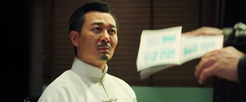 Movie still from “Ip Man 4: The Finale” (2019), directed by Wilson Yip – A person wearing a white shirt; Close Up shot, Low angle