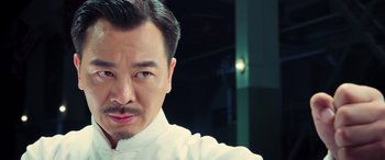 Movie still from “Ip Man 4: The Finale” (2019), directed by Wilson Yip – A person wearing a white shirt; Close Up shot, Low angle