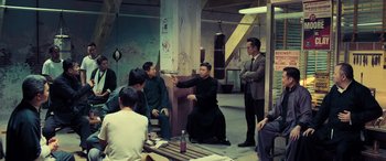 Movie still from “Ip Man 4: The Finale” (2019), directed by Wilson Yip – A group of people sitting in a room; Wide shot, High angle