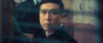 Movie still from “Ip Man 4: The Finale” (2019), directed by Wilson Yip – A person looking at the camera; Close Up shot, Low angle